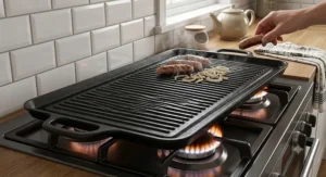 Large double burner cast iron griddle pan stretching across two gas cooker rings