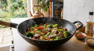 A freshly cooked healthy beef and broccoli stir fry served hot inside a classic cast iron wok.