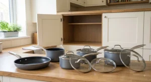 Affordable 5-piece pan set under £100 including three saucepans with lids, a frying pan, and a milk pan