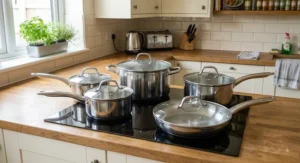Stainless steel 5-piece pan set under £100 featuring clear tempered glass lids and steam vents